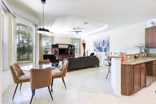 17560 72nd Rd N, The Acreage, FL 33470 - dining space featuring a raised ceiling, a ceiling fan, arched walkways, and light tile patterned floors