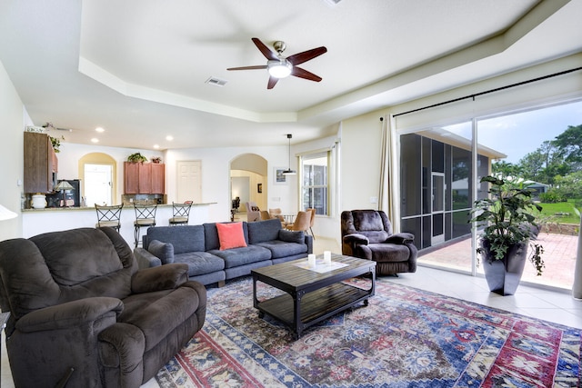 17560 72nd Rd N, The Acreage, FL 33470 - living room featuring a tray ceiling, a ceiling fan, arched walkways, light tile patterned floors, and recessed lighting