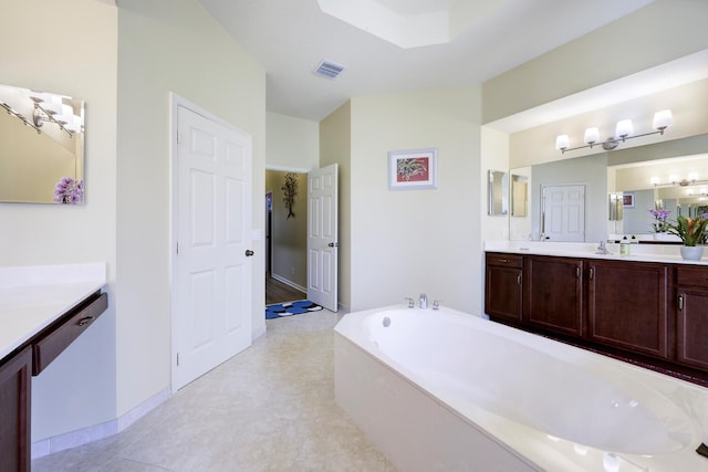 17560 72nd Rd N, The Acreage, FL 33470 - bathroom featuring a garden tub, vanity, and baseboards