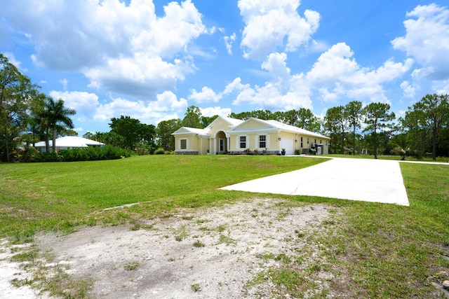 17560 72nd Rd N, The Acreage, FL 33470 - back of house with concrete driveway, a yard, and an attached garage