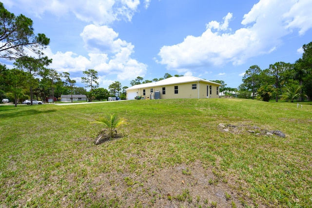 17560 72nd Rd N, The Acreage, FL 33470 - view of grassy yard with an attached garage