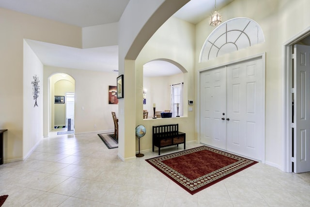 17560 72nd Rd N, The Acreage, FL 33470 - tiled entrance foyer featuring arched walkways, baseboards, and a high ceiling
