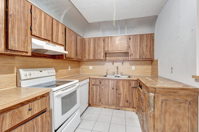6160 SW 4th St, Margate, FL 33068 - kitchen featuring white appliances, under cabinet range hood, a sink, light tile patterned floors, and light countertops