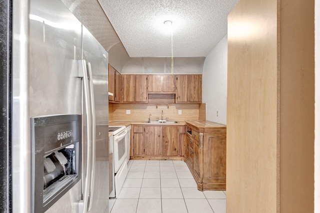 6160 SW 4th St, Margate, FL 33068 - kitchen with stainless steel fridge with ice dispenser, a sink, white electric stove, a textured ceiling, and light tile patterned flooring