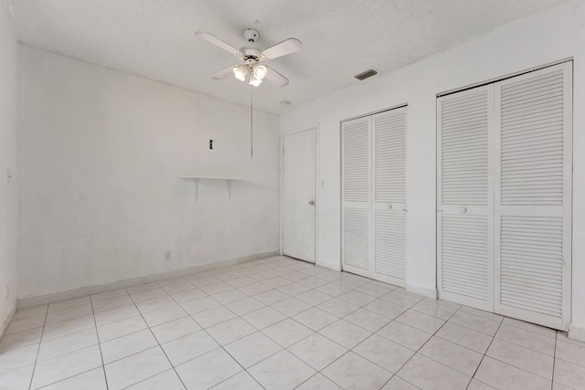 6160 SW 4th St, Margate, FL 33068 - unfurnished bedroom with multiple closets, light tile patterned flooring, a ceiling fan, and baseboards