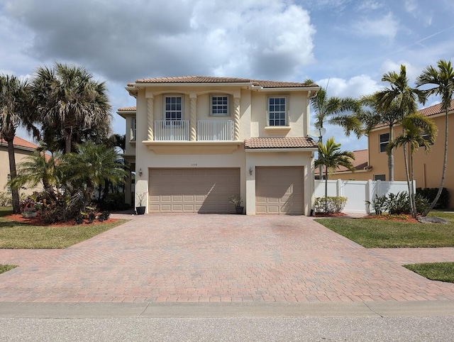 3104 SW Porpoise Cir, Stuart, FL 34997 - mediterranean / spanish-style home with a garage, decorative driveway, stucco siding, and a tiled roof