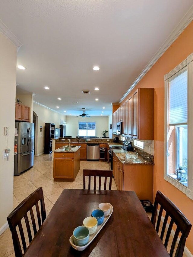 3104 SW Porpoise Cir, Stuart, FL 34997 - dining area featuring ornamental molding, recessed lighting, light tile patterned floors, and a ceiling fan