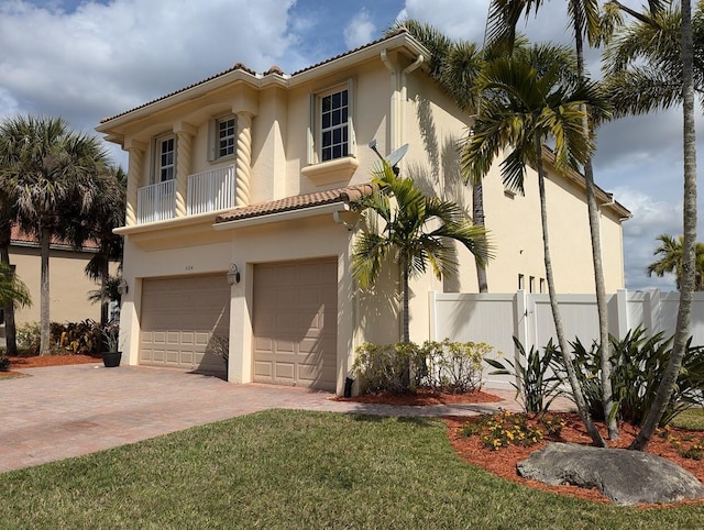 3104 SW Porpoise Cir, Stuart, FL 34997 - mediterranean / spanish-style home featuring a garage, stucco siding, a tile roof, decorative driveway, and a balcony