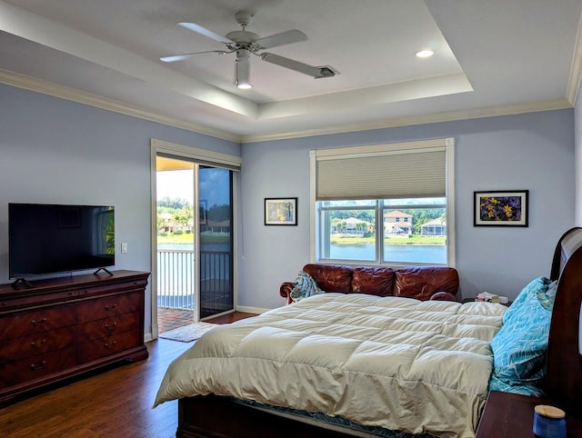 3104 SW Porpoise Cir, Stuart, FL 34997 - bedroom featuring a tray ceiling, dark wood-style flooring, access to outside, recessed lighting, and crown molding