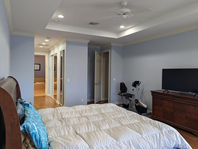 3104 SW Porpoise Cir, Stuart, FL 34997 - bedroom with recessed lighting, a raised ceiling, wood finished floors, ensuite bath, and crown molding