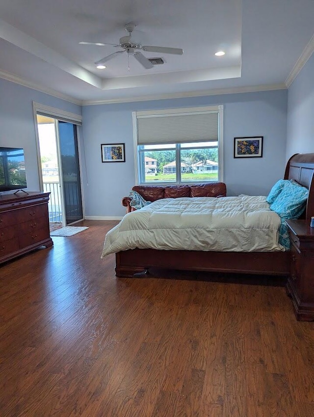 3104 SW Porpoise Cir, Stuart, FL 34997 - bedroom featuring a raised ceiling, multiple windows, wood finished floors, baseboards, and crown molding