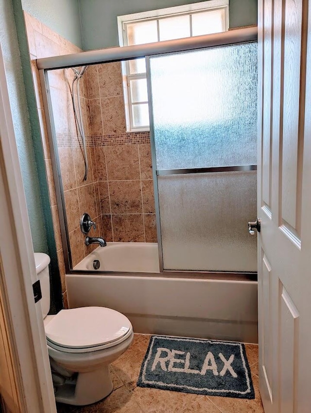 3104 SW Porpoise Cir, Stuart, FL 34997 - bathroom featuring toilet and bath / shower combo with glass door