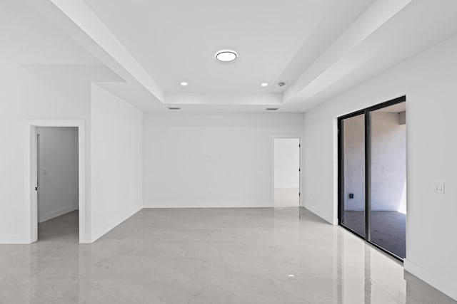 620 Raintree St E, Lehigh Acres, FL 33974 - spare room featuring recessed lighting, a raised ceiling, light marble finish flooring, and baseboards