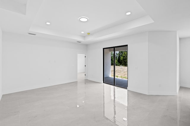 620 Raintree St E, Lehigh Acres, FL 33974 - unfurnished room with a tray ceiling, recessed lighting, baseboards, and light marble finish flooring