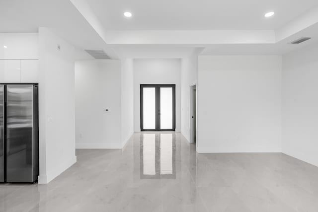 620 Raintree St E, Lehigh Acres, FL 33974 - spare room featuring french doors, recessed lighting, baseboards, a raised ceiling, and light marble finish floors