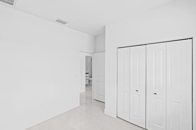 620 Raintree St E, Lehigh Acres, FL 33974 - unfurnished bedroom with baseboards and a closet