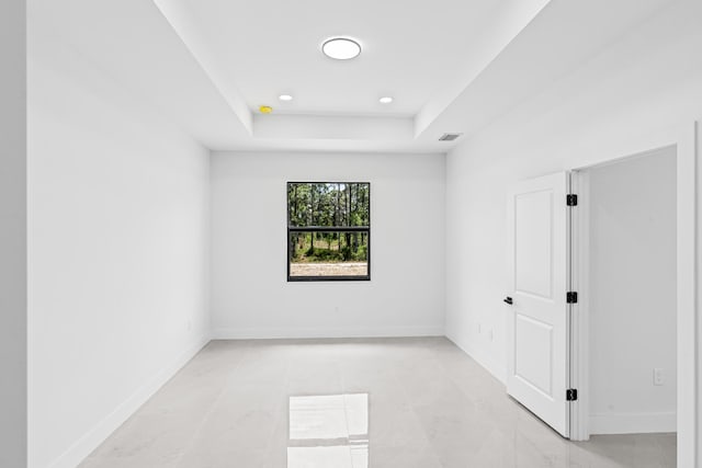 620 Raintree St E, Lehigh Acres, FL 33974 - unfurnished room featuring a raised ceiling, baseboards, and recessed lighting