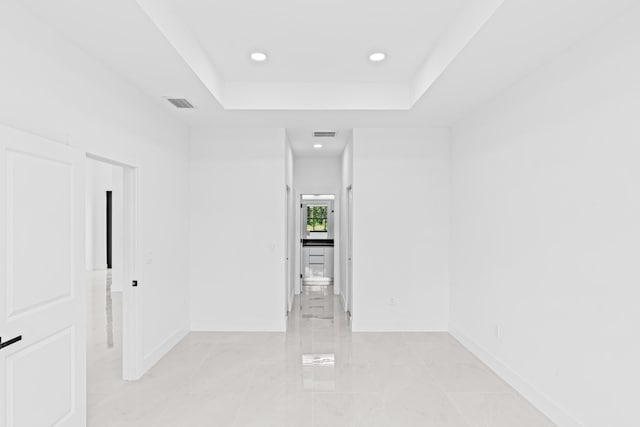 620 Raintree St E, Lehigh Acres, FL 33974 - spare room with baseboards, recessed lighting, a tray ceiling, and light marble finish floors