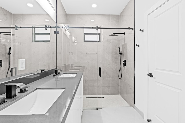 620 Raintree St E, Lehigh Acres, FL 33974 - bathroom with double vanity, a stall shower, and recessed lighting