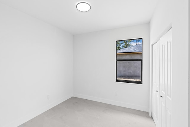 620 Raintree St E, Lehigh Acres, FL 33974 - empty room with baseboards and light marble finish flooring