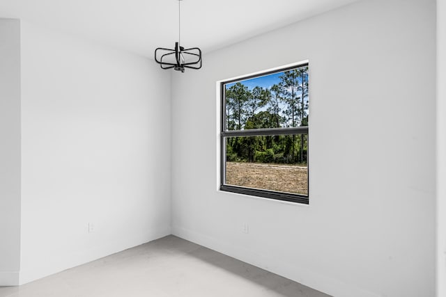 620 Raintree St E, Lehigh Acres, FL 33974 - empty room with a chandelier and baseboards