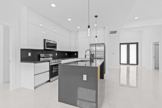 620 Raintree St E, Lehigh Acres, FL 33974 - kitchen with appliances with stainless steel finishes, modern cabinets, a sink, dark countertops, and white cabinetry