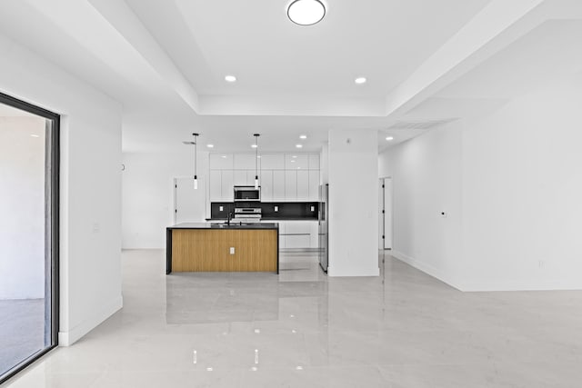 620 Raintree St E, Lehigh Acres, FL 33974 - kitchen featuring stainless steel appliances, open floor plan, modern cabinets, white cabinetry, and baseboards