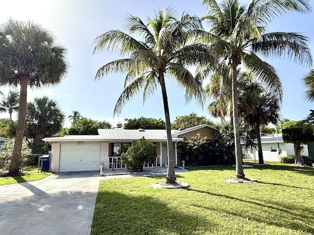 1810 Eucalyptus Ave, Fort Pierce, FL 34949 - view of front facade featuring a garage, driveway, and a front lawn