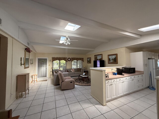 1810 Eucalyptus Ave, Fort Pierce, FL 34949 - living area featuring a skylight, light tile patterned flooring, and a ceiling fan