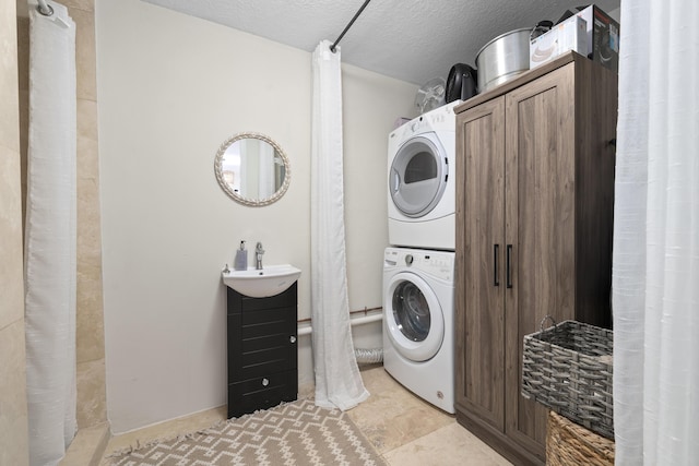 1501 S Palmway, Lake Worth, FL 33460 - laundry area with stacked washing machine and dryer and a textured ceiling