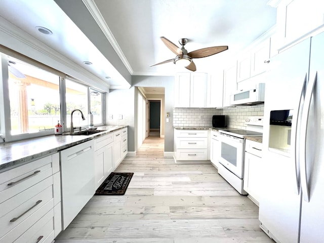 115 Sandpiper Ave, Royal Palm Beach, FL 33411 - kitchen featuring white appliances, a sink, ornamental molding, white cabinetry, and tasteful backsplash