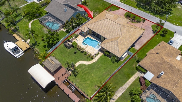 401 SE Verada Ave, Port Saint Lucie, FL 34983 - view from above of property featuring a pool and a nearby body of water