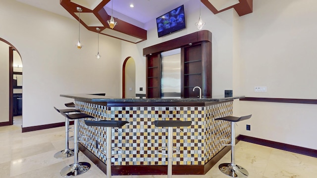 401 SE Verada Ave, Port Saint Lucie, FL 34983 - indoor wet bar with arched walkways, baseboards, and tile patterned floors