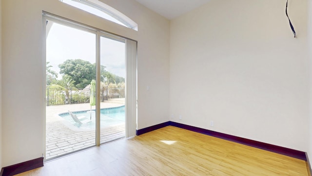 401 SE Verada Ave, Port Saint Lucie, FL 34983 - spare room with plenty of natural light, wood finished floors, and baseboards