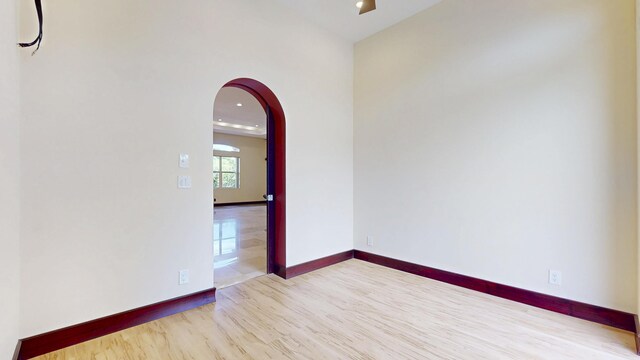 401 SE Verada Ave, Port Saint Lucie, FL 34983 - empty room with wood finished floors, arched walkways, baseboards, and recessed lighting