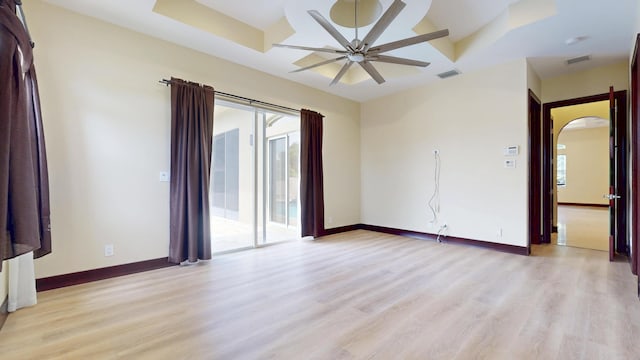 401 SE Verada Ave, Port Saint Lucie, FL 34983 - unfurnished room with light wood-style floors, a ceiling fan, arched walkways, and baseboards