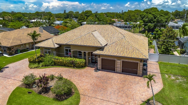 401 SE Verada Ave, Port Saint Lucie, FL 34983 - view of front of property with a tile roof, a garage, a gate, decorative driveway, and stucco siding