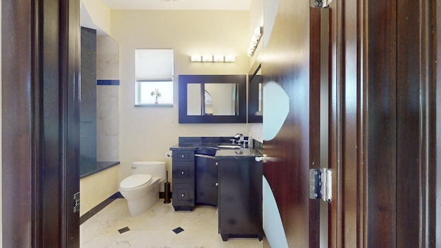 401 SE Verada Ave, Port Saint Lucie, FL 34983 - bathroom with toilet, vanity, and baseboards