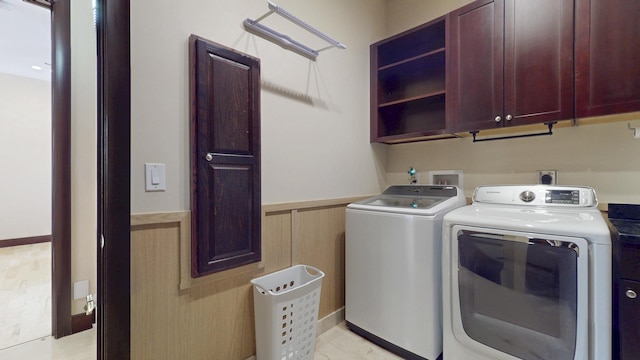 401 SE Verada Ave, Port Saint Lucie, FL 34983 - laundry area with cabinet space, washing machine and dryer, and a wainscoted wall