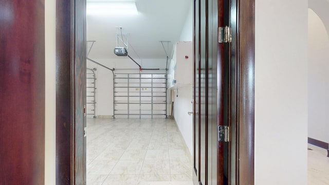 401 SE Verada Ave, Port Saint Lucie, FL 34983 - garage featuring a garage door opener and baseboards