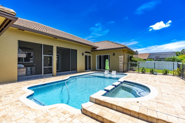 401 SE Verada Ave, Port Saint Lucie, FL 34983 - view of swimming pool featuring a pool with connected hot tub, a patio, and a sunroom