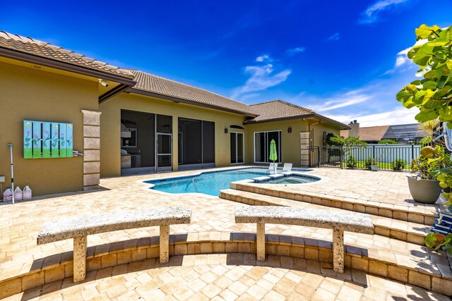 401 SE Verada Ave, Port Saint Lucie, FL 34983 - view of pool with a patio area, a sunroom, and an in-ground hot tub