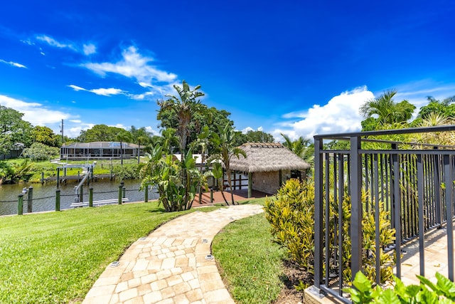 401 SE Verada Ave, Port Saint Lucie, FL 34983 - view of green lawn featuring boat lift, a boat dock, and a water view