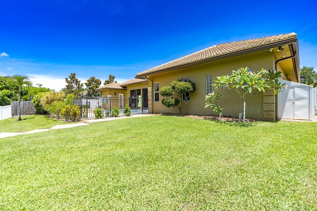 401 SE Verada Ave, Port Saint Lucie, FL 34983 - rear view of property with stucco siding and a tile roof