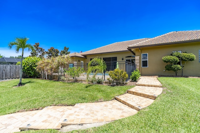 401 SE Verada Ave, Port Saint Lucie, FL 34983 - rear view of house with stucco siding, a patio, and a tiled roof