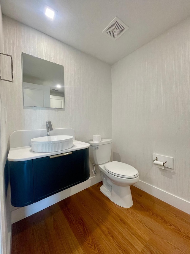 6159 Peaceful Park Way, Clermont, FL 34714 - bathroom featuring wood finished floors, toilet, vanity, and baseboards