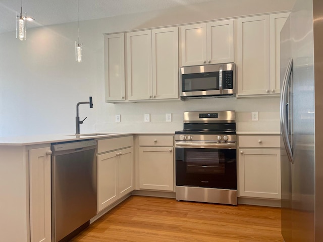6159 Peaceful Park Way, Clermont, FL 34714 - kitchen featuring appliances with stainless steel finishes, a sink, light countertops, and a peninsula