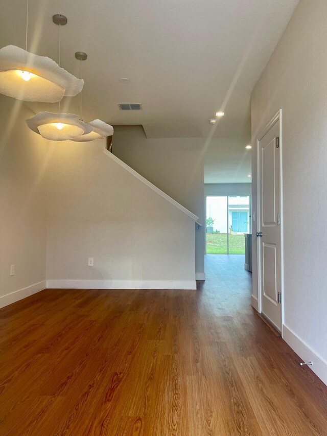6159 Peaceful Park Way, Clermont, FL 34714 - unfurnished living room with wood finished floors and baseboards