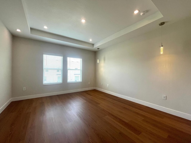 6159 Peaceful Park Way, Clermont, FL 34714 - spare room with a raised ceiling, baseboards, dark wood-style floors, and recessed lighting