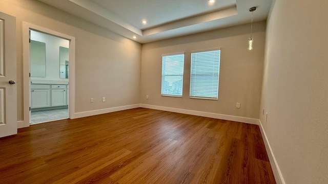6159 Peaceful Park Way, Clermont, FL 34714 - empty room featuring wood finished floors, baseboards, a raised ceiling, and recessed lighting